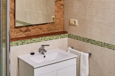 a bathroom with a sink and a mirror at Escola de Bieite in Boimorto