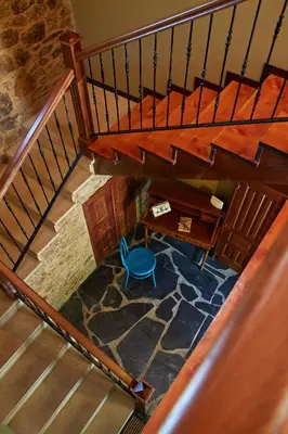 an overhead view of a staircase with a blue chair at Escola de Bieite in Boimorto
