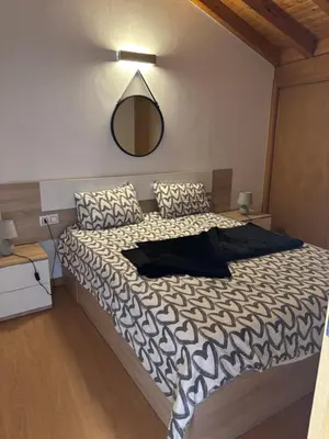 a bedroom with a large bed with a mirror on the wall at Casa Fidalgo in Ribadavia