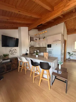a kitchen with a table and chairs in a room at Casa Fidalgo in Ribadavia