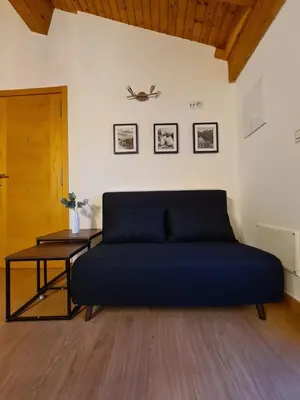 a blue bed in a room with a table at Casa Fidalgo in Ribadavia