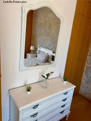 a dresser with a mirror on top of it at Casa Fidalgo in Ribadavia