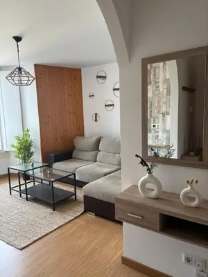 a living room with a couch and a mirror at Casa Fidalgo in Ribadavia