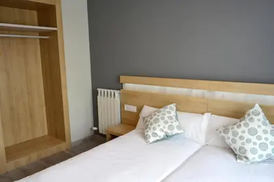 a bedroom with a bed with two pillows on it at Alda Catedral in Santiago de Compostela