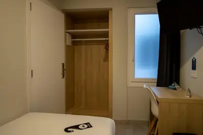 a room with a bed and a window and a door at Alda Catedral in Santiago de Compostela