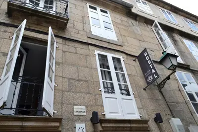 a building with white doors and windows on it at Alda Catedral in Santiago de Compostela