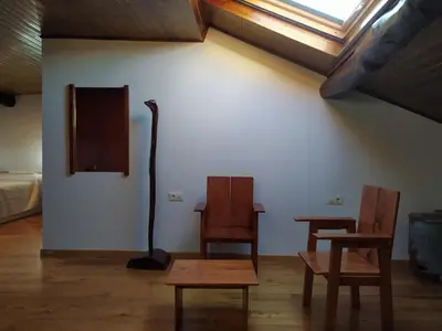 two chairs and a table in a room with a window at Casa das Pozas 2 in Monforte de Lemos