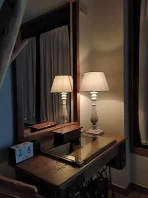 two lamps on a table in front of a mirror at Casa das Pozas 2 in Monforte de Lemos