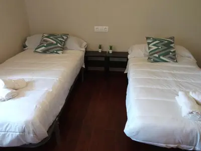 two beds sitting next to each other in a room at CASA ISAURA DE PENA Camino Primitivo in Pacio