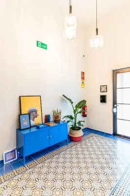 a room with a blue cabinet and a potted plant at Four Rooms Hostel in Lugo