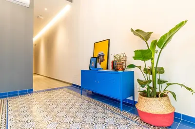 a hallway with a blue cabinet and a potted plant at Four Rooms Hostel in Lugo
