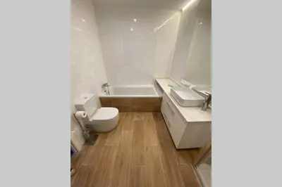 a bathroom with a toilet and a sink and a tub at El Taller de Doña Remedios in Mondoñedo