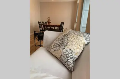 a white couch with a pillow on top of it at El Taller de Doña Remedios in Mondoñedo