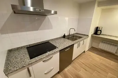 a kitchen with a sink and a counter top at El Taller de Doña Remedios in Mondoñedo