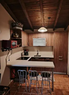 a living room with a fireplace and a television at Finca O Loureiro in Amés
