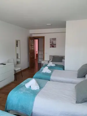 two beds sitting next to each other in a bedroom at Pension Myriam O PEDROUZO in O Pedrouzo