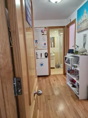 a room with a door and a kitchen with a refrigerator at Pension Myriam O PEDROUZO in O Pedrouzo