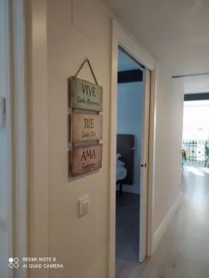 a room with a wall with signs on it at Apartamentos Pontedeume Riadoeume in Puentedeume