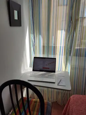 a laptop computer sitting on a table next to a window at Apartamento Faro de Tapia in Tapia de Casariego