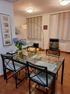 a living room with a glass table and chairs at Apartamento Faro de Tapia in Tapia de Casariego