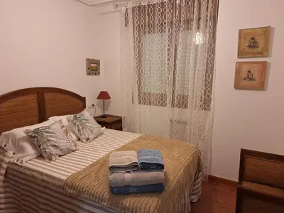 a bedroom with a bed with two towels on it at Apartamento Faro de Tapia in Tapia de Casariego