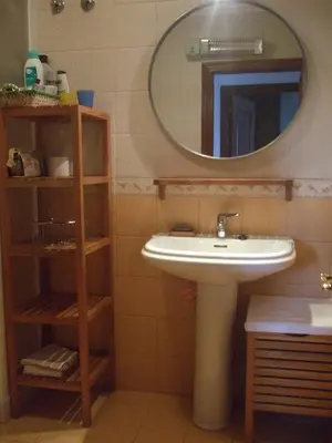 a bathroom with a sink and a mirror at Apartamento Faro de Tapia in Tapia de Casariego