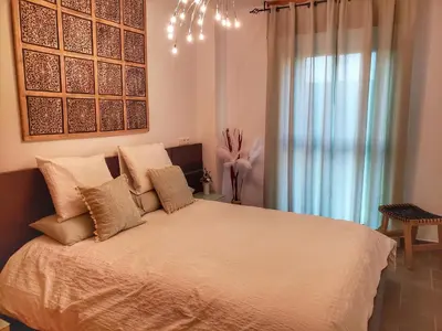 a bedroom with a bed with pillows and a window at Santiago Sur, Camino Portugués in Milladoiro