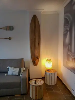 a living room with a couch and a table with a lamp at Santiago Sur, Camino Portugués in Milladoiro