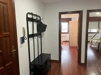 a hallway with a room with a bed and a black shelf at Apartamento Bralo in Padrón