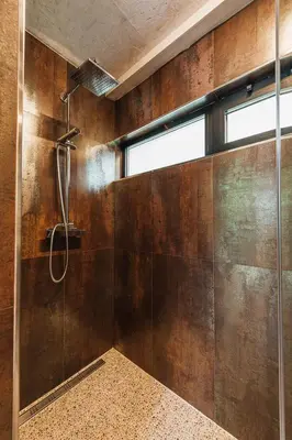 a bathroom with a shower with a glass wall at Maxia Galega -Arte, Natureza, Relax -Ribeira Sacra in Monforte de Lemos