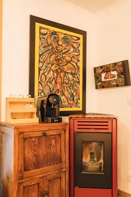 a room with a fireplace and a painting on the wall at Maxia Galega -Arte, Natureza, Relax -Ribeira Sacra in Monforte de Lemos