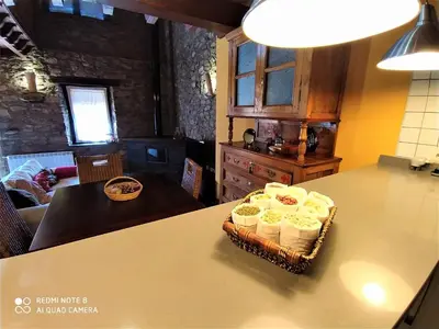 a basket of food on a table in a kitchen at La obra de Joaquin, tu rincón en el Bierzo alto in Folgoso de la Ribera