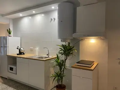 a kitchen with a sink and a refrigerator at Apartamento Padron Centro P8 by URent in Padrón