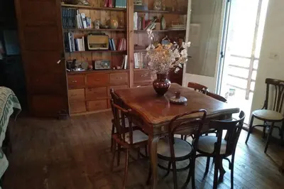 a dining room table with chairs and a vase with flowers on it at Casa Ribeira Sacra, Ourense, Niñodaguia, Galicia in Ourense