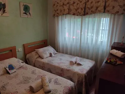 a bedroom with two beds and a window at A Chabola Mondariz in Pontevedra