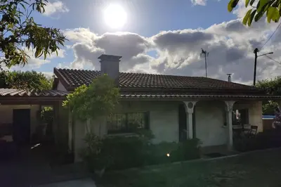 a house with a roof with the sun in the sky at A Chabola Mondariz in Pontevedra