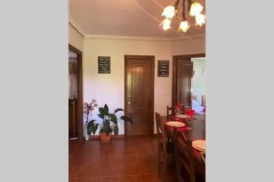 a living room with a table and a dining room at A Chabola Mondariz in Pontevedra