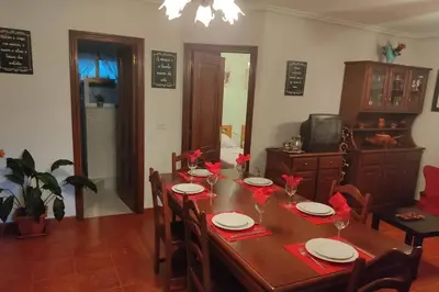 a dining room table with red napkins and plates on it at A Chabola Mondariz in Pontevedra