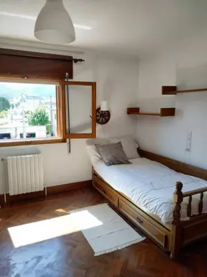 a bedroom with a bed and a large window at Covas Beach Arena in Viveiro