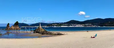 a beach with a group of rocks in the sand at Covas Beach Arena in Viveiro