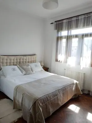 a white bedroom with a large bed with windows at Covas Beach Arena in Viveiro