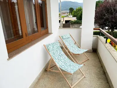 two chairs sitting on the porch of a house at Covas Beach Arena in Viveiro