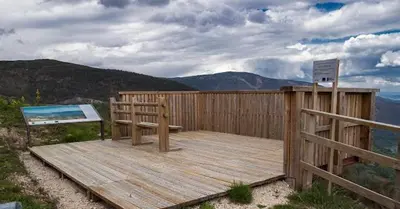 a wooden deck with a bench on top of a mountain at Casa 2 Gallos in Ourense