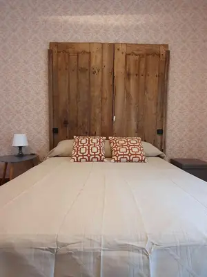 a large bed with two pillows on top of it at Casa 2 Gallos in Ourense