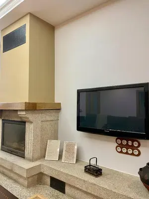 a living room with a tv and a fireplace at A Casa de Pia in Sober