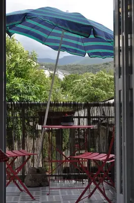 a table and chairs under an umbrella on a patio at Ollar do Cido in Seoane