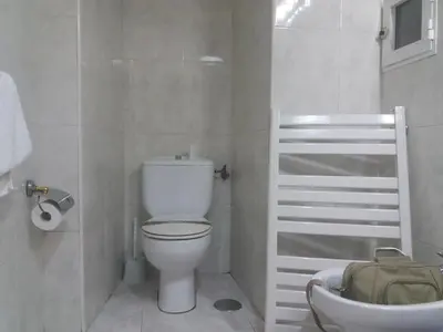 a bathroom with a sink and a toilet and a mirror at Ollar do Cido in Seoane