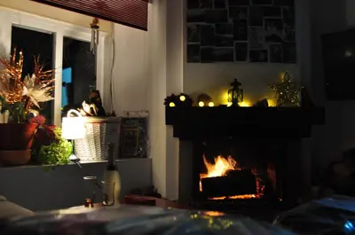 a fireplace with a fire in it at Ollar do Cido in Seoane