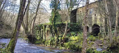 an old building on the side of a river at Ollar do Cido in Seoane