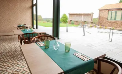 a table with a green table cloth on top at Casa Rico de Medín in O Pino